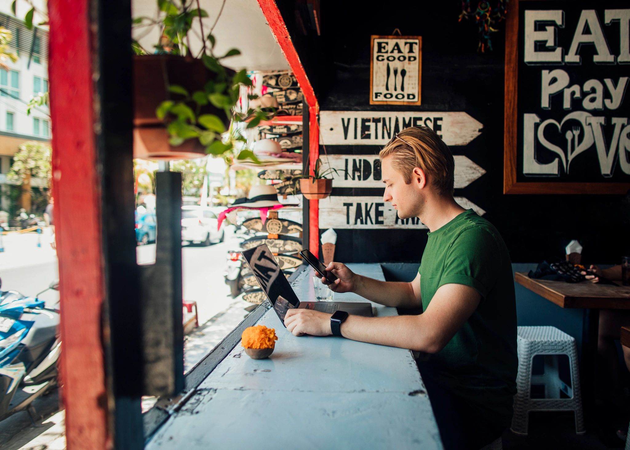 Remote worker using a laptop at a café in Bali