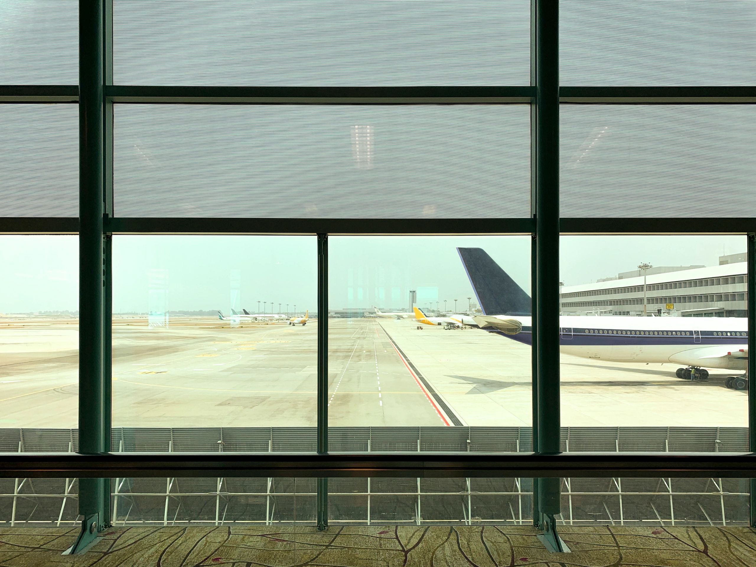 Airplane runway viewed from an airport window in Singapore