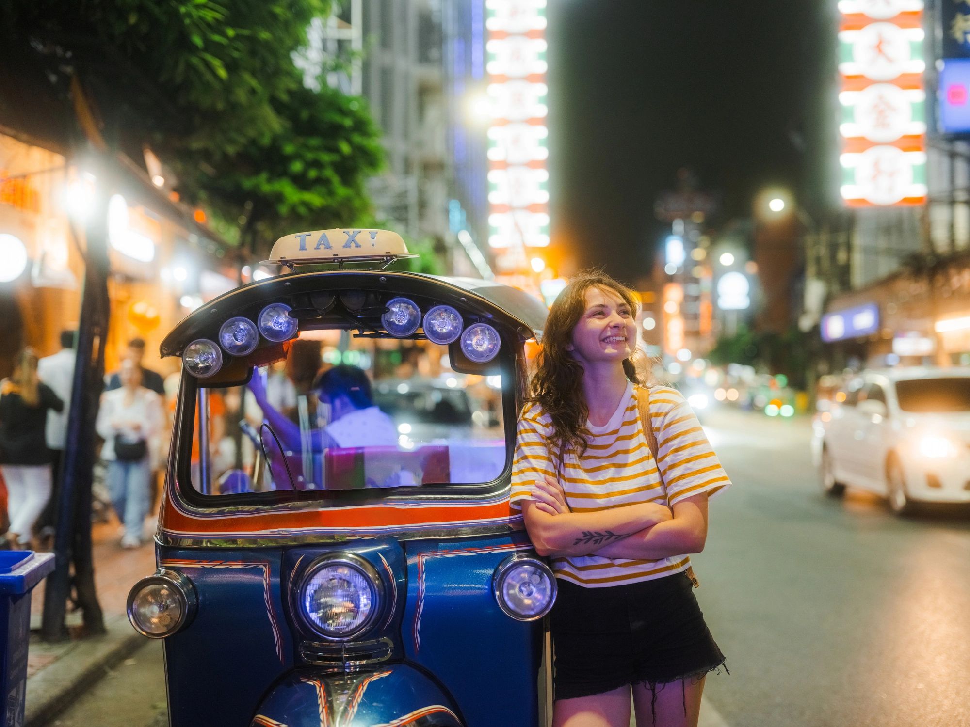 Woman near a tuk-tuk in Bangkok Chinatown