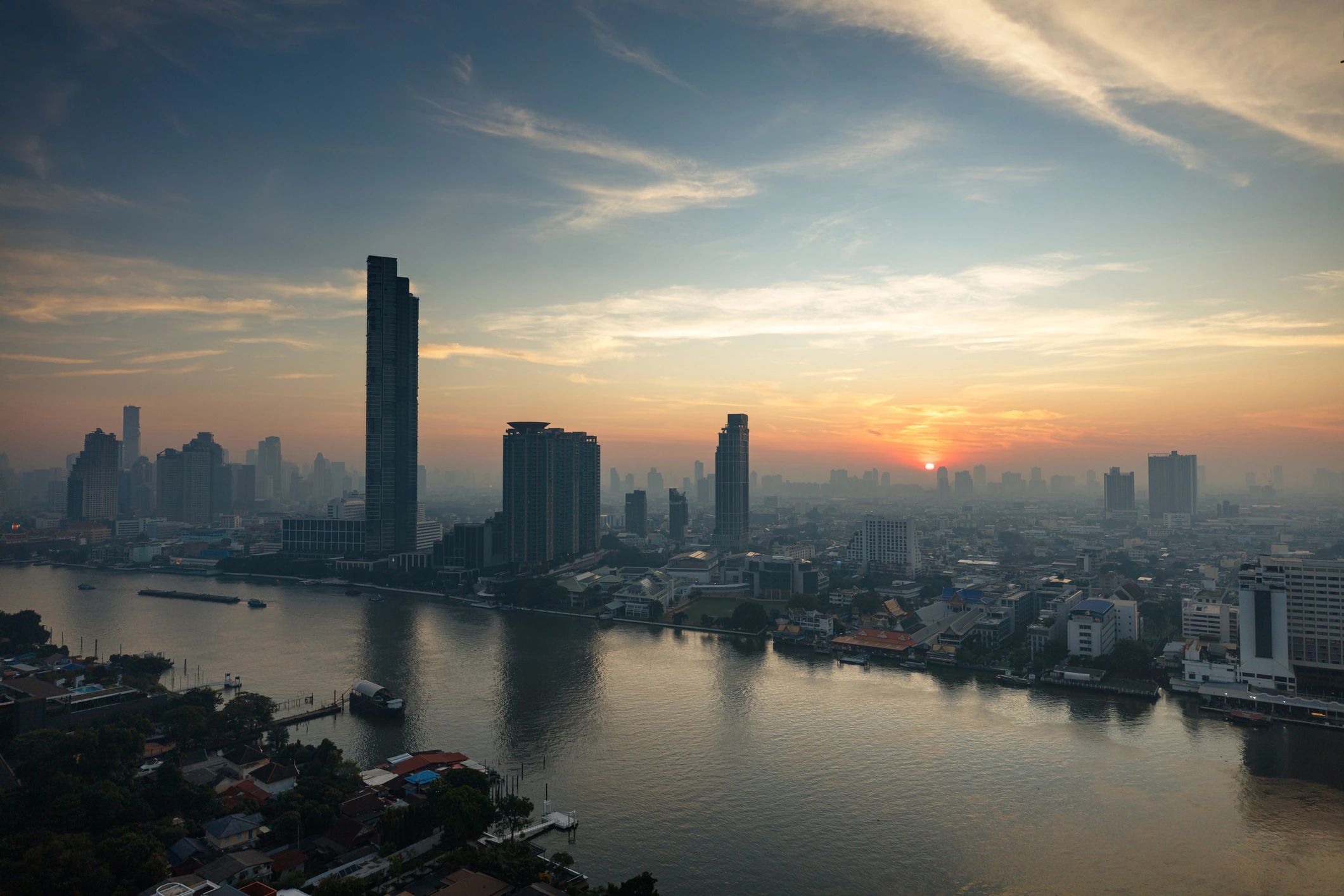 Bangkok skyline at sunset over the Chao Phraya River
