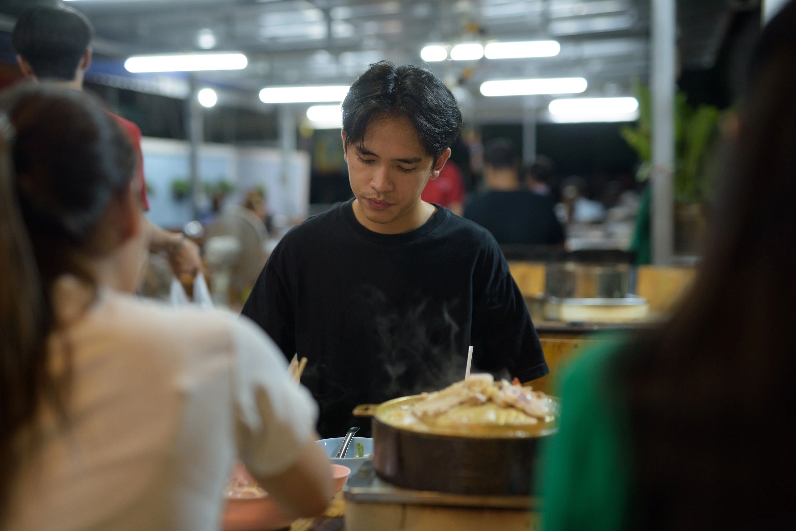 Friends eating Thai barbecue at night