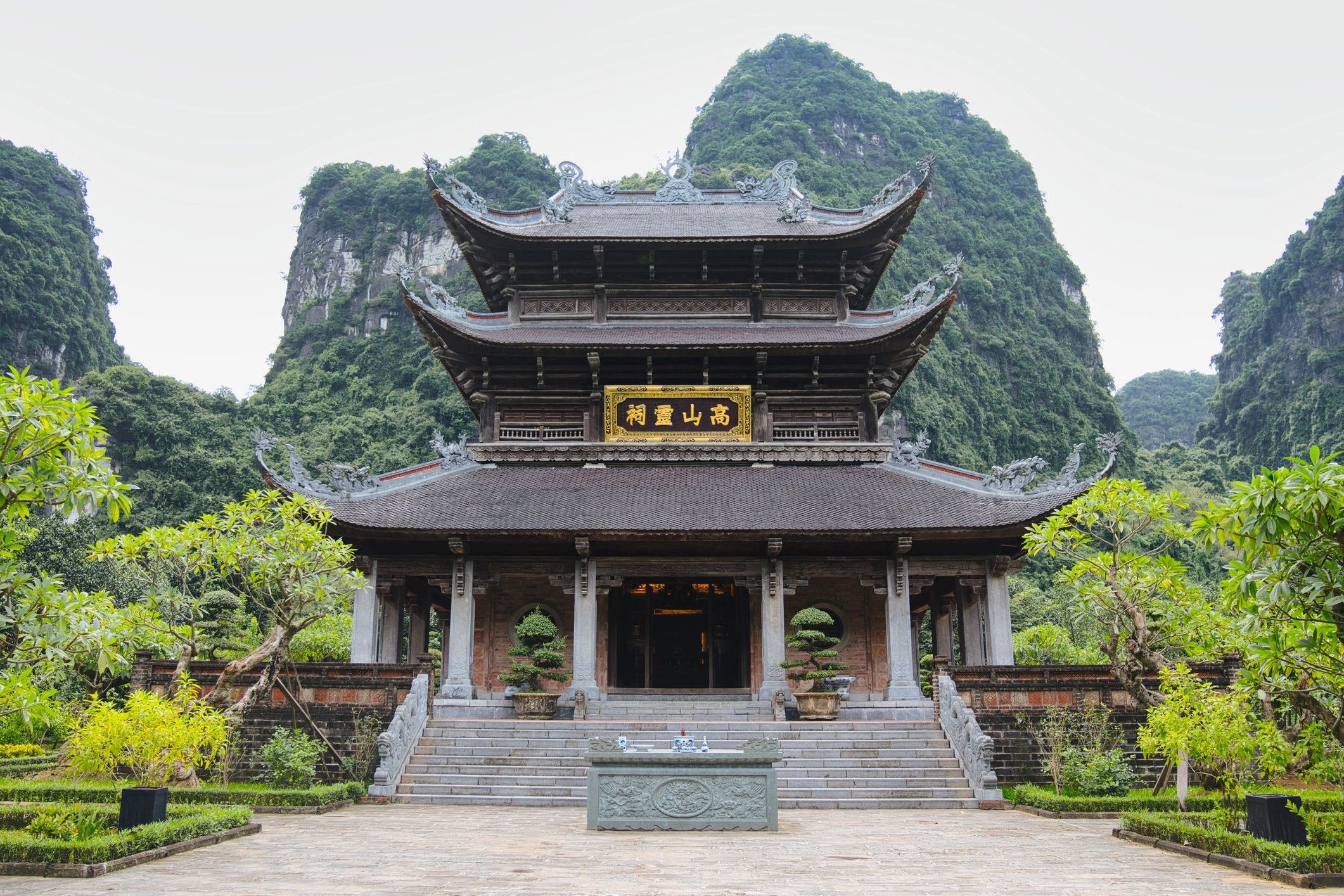 Pagoda near limestone mountains and greenery