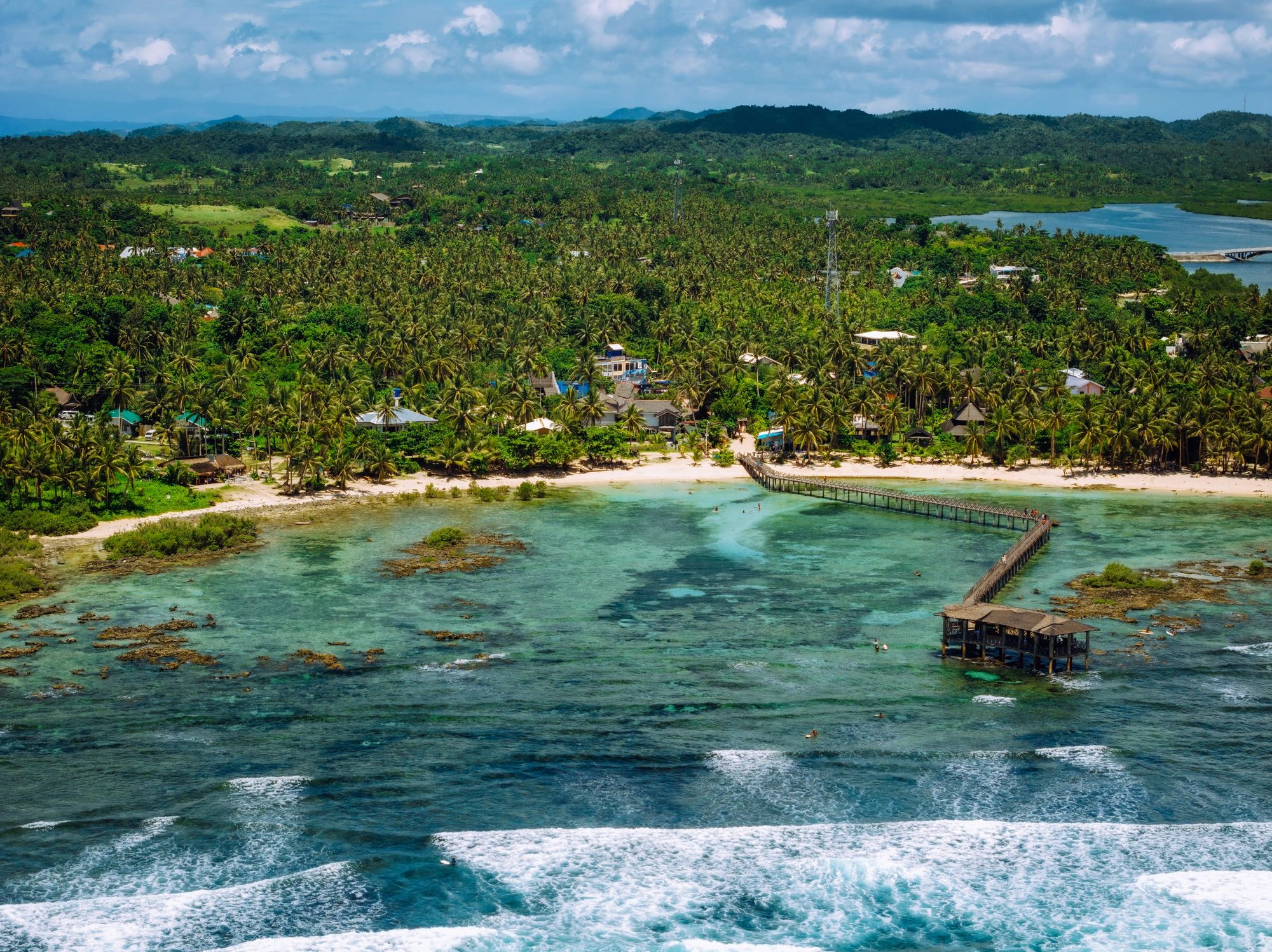 Aerial view of Siargao coastline with pier