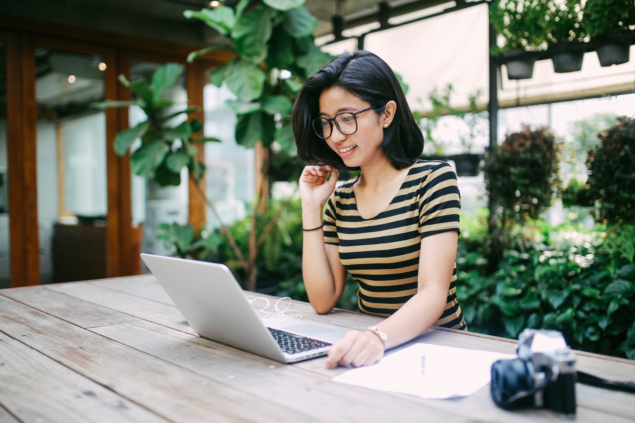 Remote worker using a laptop in a cafe in Thailand